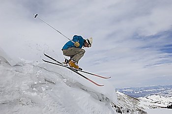 Skier Jumping Off Icy Overhang