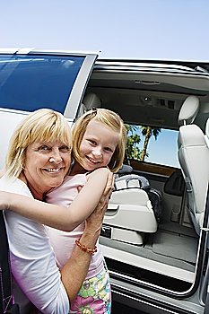 Mother Hugging Daughter by Minivan
