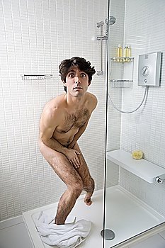 Scared naked man in bathroom