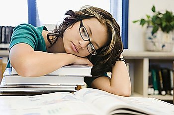 High School Student Sleeping on a Stack of Books