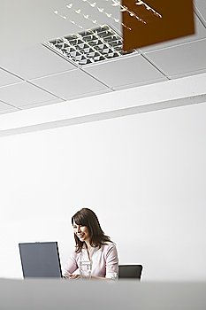 Woman working on laptop in office