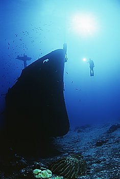 Diver exploring bow of sunken fishing trawler