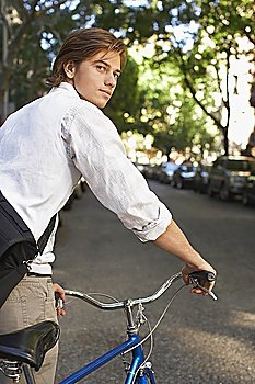 Man riding bicycle in residential district, close-up