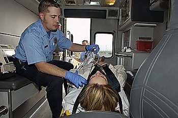 Paramedic taking care of victim in ambulance