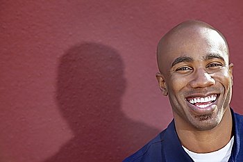 Portrait of a cheerful African American man over colored background