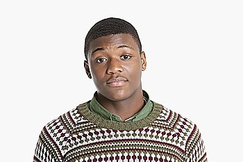Portrait of an African American young man in sweater over gray background