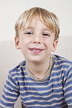 Close-up portrait of cute young boy smiling