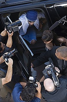 Male celebrity and paparazzi high angle