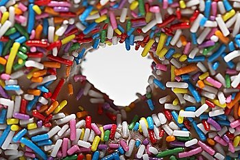 Rainbow sprinkles on doughnut, close-up