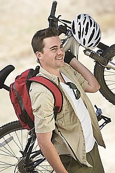Man carrying mountain bike