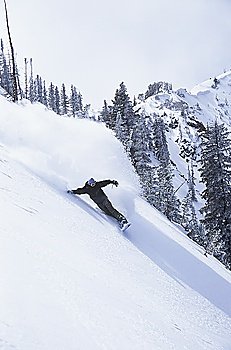 Snowboarder Descending Snowy Slope