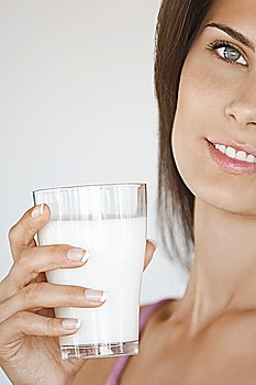 Young Woman Holding Glass of Milk