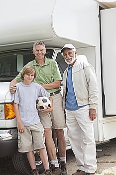 Father son and grandson stand with RV home