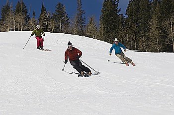 Skiers Skiing Down Slope