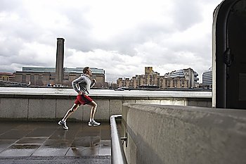 Man jogging opposite Tate Modern