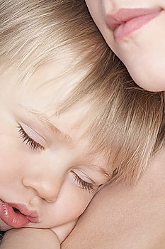 Mother cuddling sleeping son (1-2), close-up