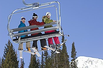 Three Skiers on Chair Lift