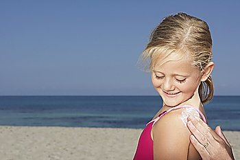 Mother applying sunscreen to daughter (5-6), close-up of hand