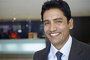 Business man standing in hotel lobby, portrait, close up