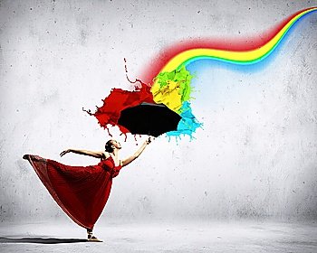 ballet dancer in flying satin dress with umbrella and a rainbow