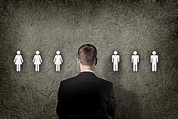 Businessman standing and making decision and choosing between people