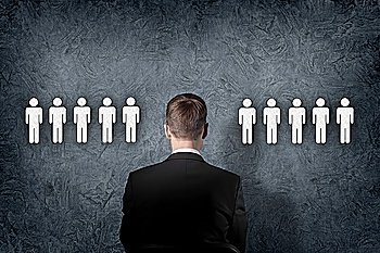 Businessman standing and making decision and choosing between people