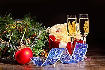 New Year´s still life with glasses of champagne. Decorations and ribbons on a bright color background