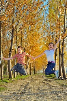 children play in forest in autumn time