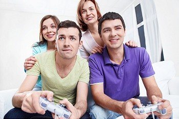 Young  friends play video games at home