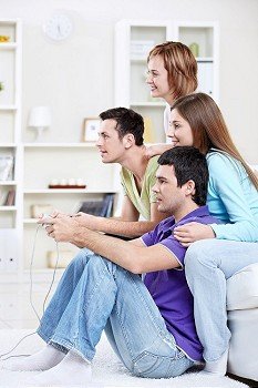 Happy friends play video games at home