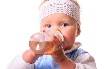 baby is drinking from plastic bottle