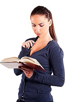 very cute young student college in casual dress readin a book