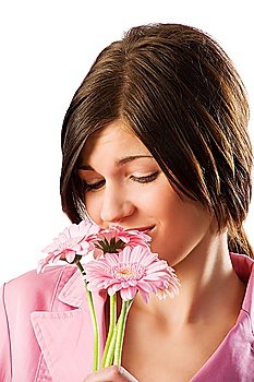 close up of cute brunette in pink smelling some flowers and making funny face