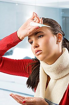 portrait of young brunette with red sweater and white scarf looking very sick