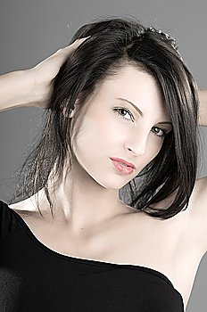 young and nice girl keeping hair up  in a black and white portrait
