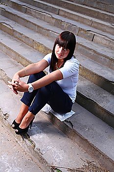 beautiful  young woman outdoors on stairs