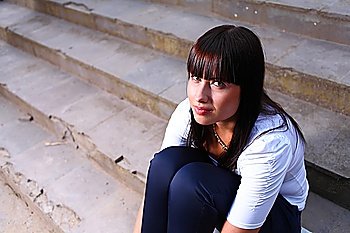 beautiful  young woman outdoors on stairs