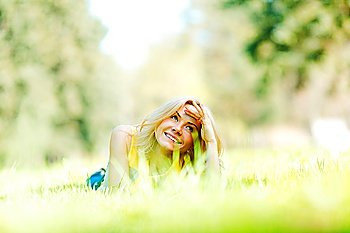 Happy young woman lying on grass