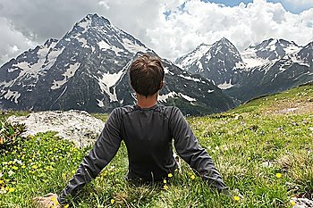 Relaxing boy in mountains