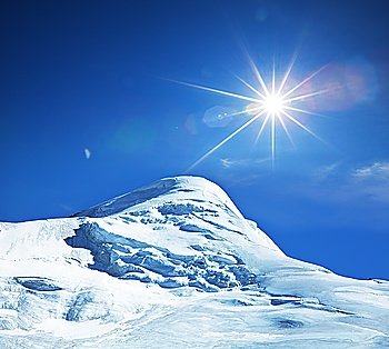snowy peak on sunny background