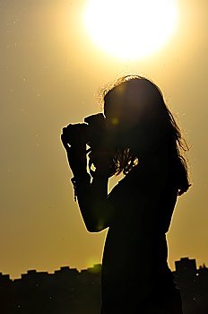 silhouette of girl isolated on sunset background in shooting time