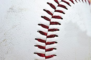 Detail image of used baseball with focus on stitching and shallow depth of field