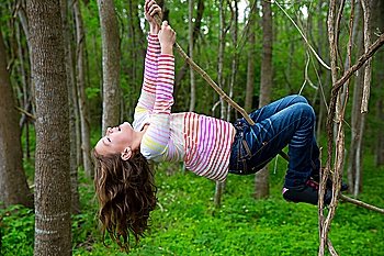 children girls playing hanging and climbing from lianas at the jungle forest park outdoor