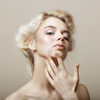 Sentimentality. Natural Blonde Woman touching her Clean Face. Pampering