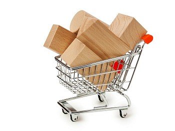 wooden blocks for the construction in shopping trolley  isolated on a white background