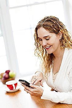 Smiling woman using smart phone