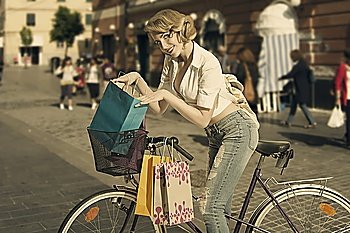 sensual blonde shopping woman win old fashion contest going for shop with bicycle with vintage color