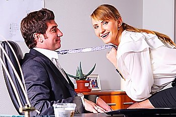businesswoman is seducing her boss at office