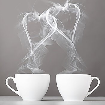 love and coffee. heart silhouettes from steaming hot coffee cups
