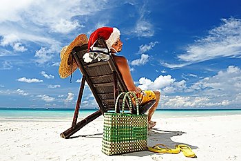 Man relaxing on the beach in santa´s hat